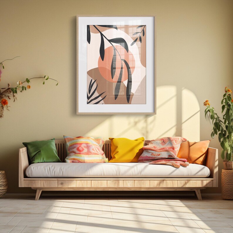 May include: A framed print with a minimalist design featuring abstract shapes and stylized leaves in shades of brown, pink, and black.