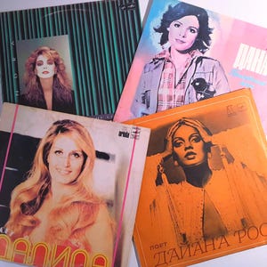 May include: A collection of vintage vinyl records featuring album covers with portraits of women. The covers display various color schemes, including pink, orange, and green. Some covers have text in different languages.