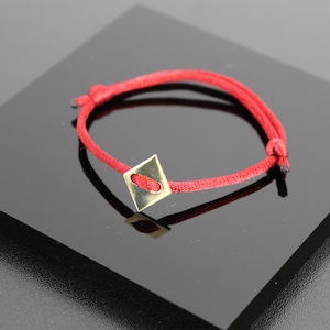 Brass tile bracelet, red cord with sliding knots