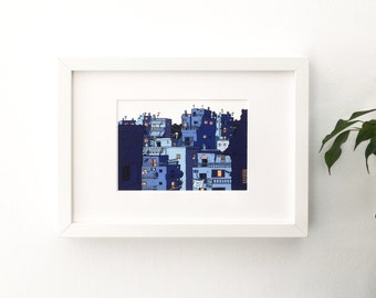 May include: A framed illustration of a cityscape at night. The buildings are a mix of blue and white, with some windows lit up. The illustration is set against a dark blue background.