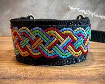 May include: Black dog collar with a colorful, woven design in rainbow hues. The collar features a repeating pattern of interwoven lines in red, yellow, green, blue, and purple. The text "DownSouthDogDesigns.com" is visible.