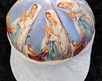 Our Lady of Lourdes motif and cap