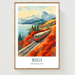 May include: Watercolor print of a train traveling through a scenic landscape. The artwork features a red and white train on tracks, surrounded by vibrant red foliage, a lake, and a snow-capped mountain. The text "Rigi Switzerland" is at the bottom.