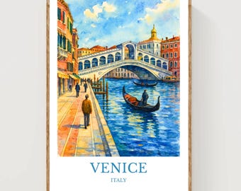 May include: Watercolor print of Venice, Italy, featuring the Rialto Bridge over a blue canal. The artwork shows gondolas, buildings in shades of orange and yellow, and people walking along the waterfront. The word "VENICE" and "ITALY" are printed at the bottom.