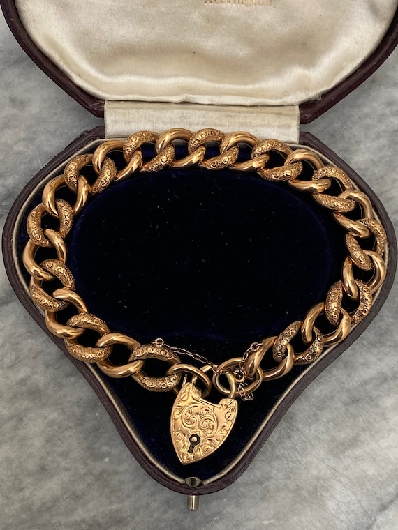 Edwardian 9ct gold, curb bracelet with a gold hear