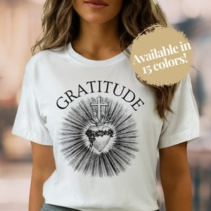 This Sacred Heart of Jesus t-shirt features a beautiful yet minimalistic design with the word GRATITUDE at the top - perfect unisex gift for any devout Catholic man or woman!
