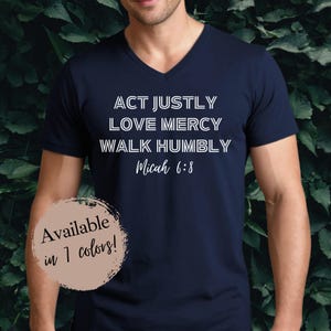 May include: Navy blue v-neck t-shirt with white text that reads "ACT JUSTLY LOVE MERCY WALK HUMBLY Micah 6:8".