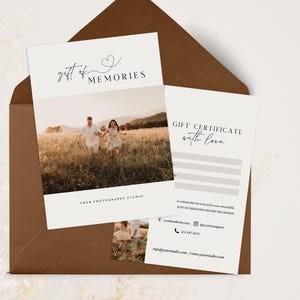 May include: A white gift certificate with the text "GIFT CERTIFICATE with love" and a photo of a couple in a field. The certificate is for a photography studio called "gift of MEMORIES".