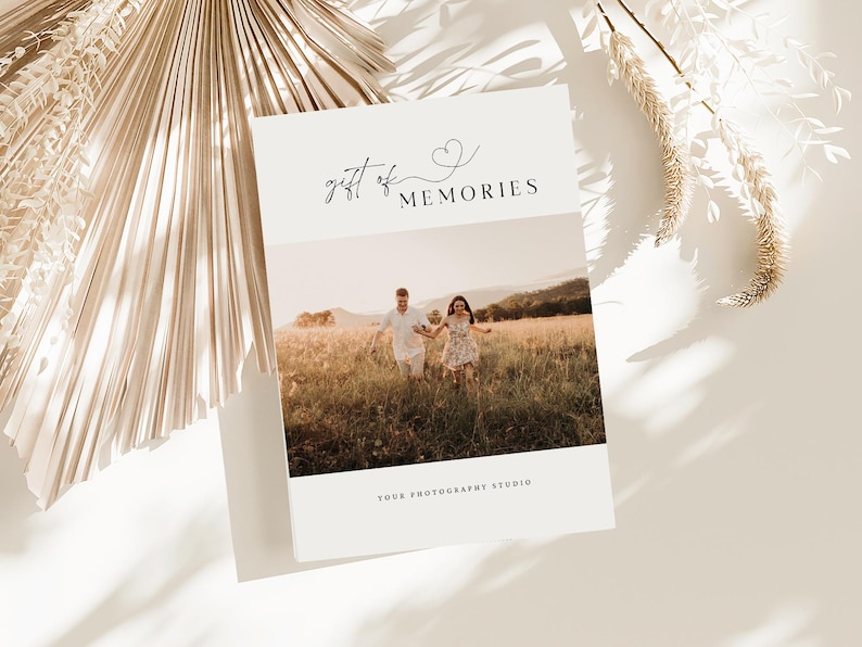 May include: A white card with the text "gift of memories" and a small heart symbol. The card has a photo of a couple running through a field.