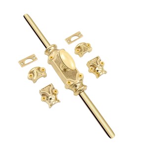 May include: A polished brass casement window fastener set featuring a central vertical rod with an oval handle, textured detailing, and four mounting brackets with small gold-colored screws. The hardware includes two rectangular strike plates.