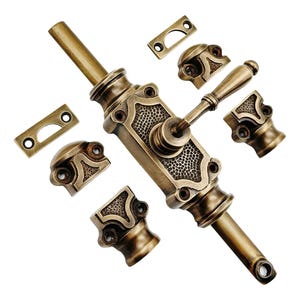 May include: An antique brass door bolt set, featuring a central bolt with a textured design, a handle, and several decorative mounting pieces. The hardware has an aged, vintage appearance.