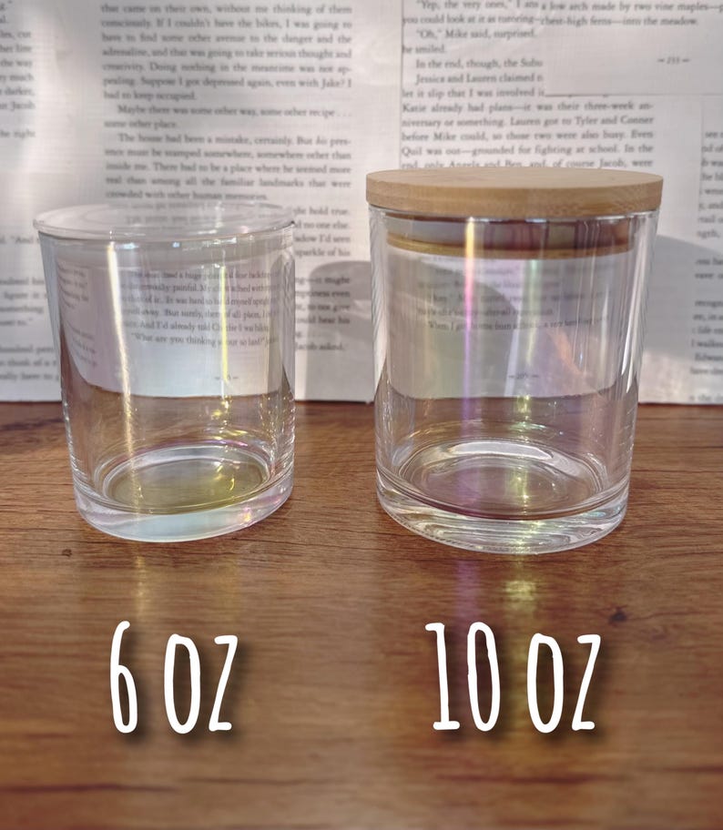 May include: Two clear glass jars with iridescent effects, one with a wooden lid. The jars are labeled with white text indicating their capacity: 6 oz and 10 oz. The jars are cylindrical and sit on a wooden surface.