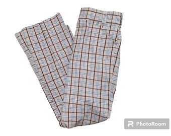 May include: A pair of plaid pants with a brown, blue, and white checkered pattern.