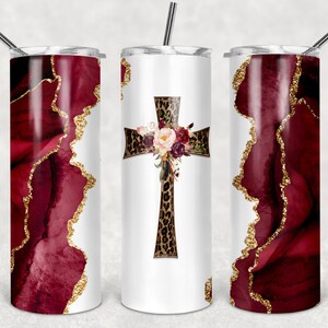 Puede incluir: Tres vasos de acero inoxidable con fondo blanco y diseño de ágata burdeos y dorado. El vaso del centro presenta una cruz de estampado de leopardo con un ramo de flores.