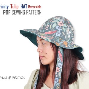 May include: A reversible green and floral patterned hat with a wide brim and long ties. The hat is called "Trinity Tulip HAT Reversible" and the text "PDF SEWING PATTERN" is also visible. The hat is being worn by a person with long dark hair.