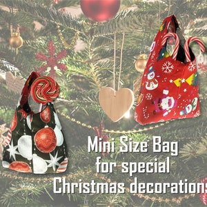 May include: Two mini Christmas-themed bags. One is black with red and white ornaments, the other is red with snowmen and Santa Claus. Both bags have handles and are filled with candy canes and a lollipop. Text reads "Mini Size Bag for special Christmas decorations."