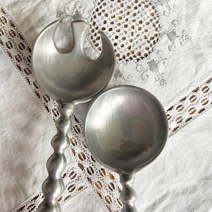 May include: A set of three ceramic nesting bowls in shades of blue, green, and white. The bowls feature a speckled glaze and a simple, modern design. The largest bowl is approximately 6 inches in diameter.
