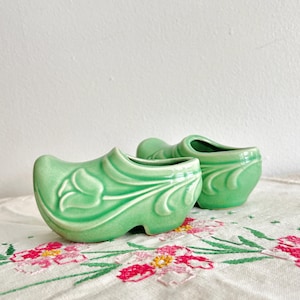 May include: A rustic wooden sign with the text "Welcome to our home" in white lettering. The sign features a distressed finish and a simple, inviting design, perfect for a front porch or entryway.