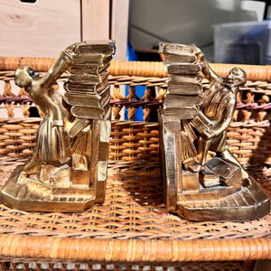 Vintage brass bookends struggling librarians