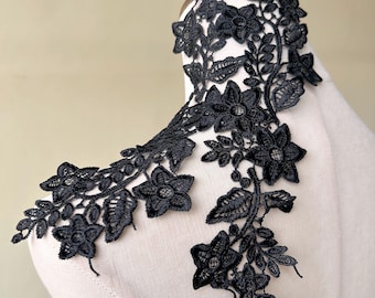 May include: Black floral lace trim with a delicate design featuring small flowers and leaves. This trim is perfect for adding a touch of elegance to any project.