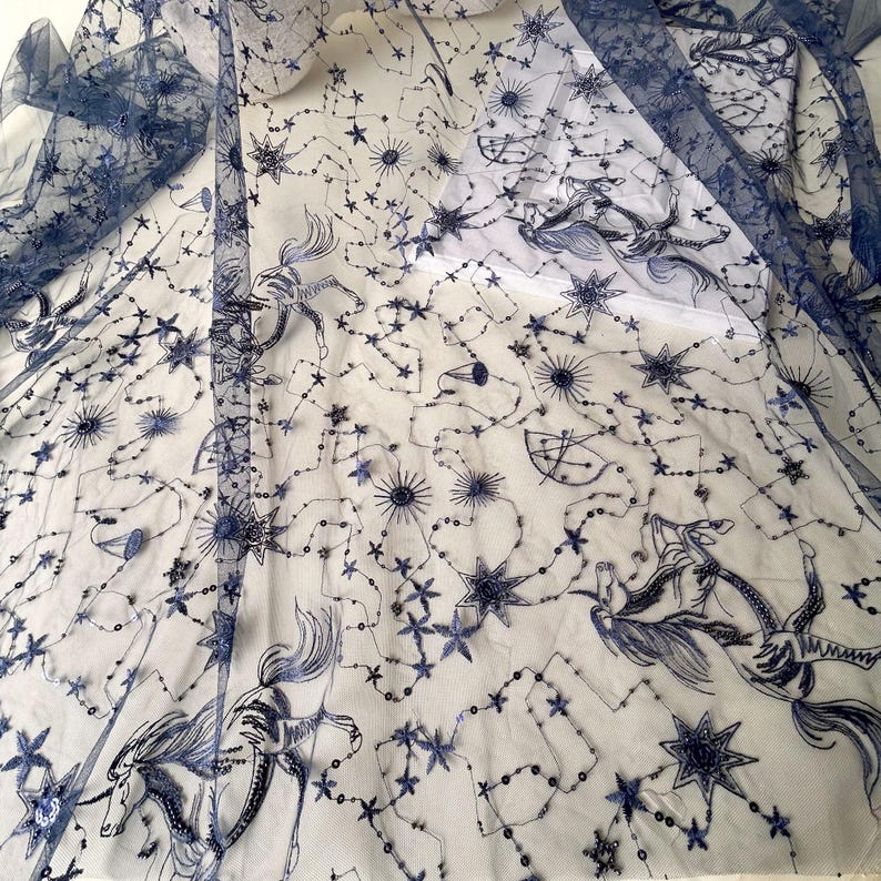 May include: Blue tulle fabric with a white background and an embroidered design of stars, constellations, and horses.