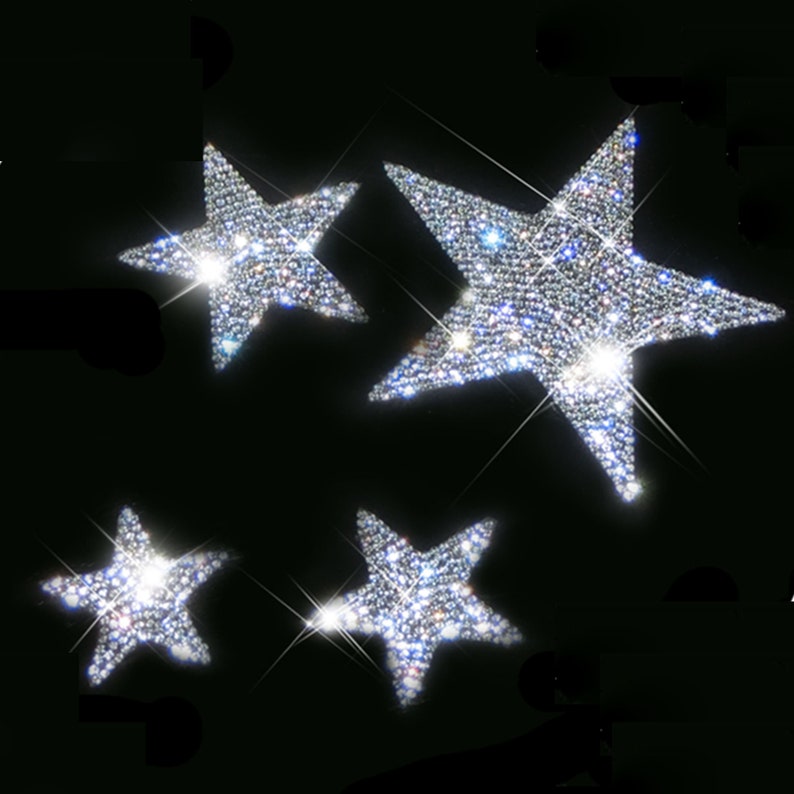 May include: Four silver sparkly star-shaped embellishments. The stars are made of rhinestones and are perfect for adding a touch of sparkle to any project.