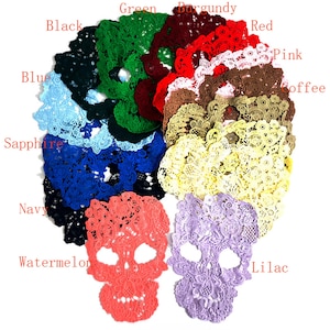 Puede incluir: Una colección de apliques de calaveras de encaje en varios colores, incluyendo negro, azul, verde, rojo y rosa. Los apliques están dispuestos en un patrón circular, con dos apliques en forma de calavera en primer plano. Los colores están etiquetados.