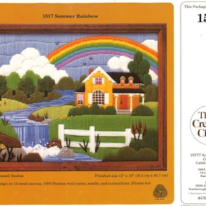 May include: A needlepoint kit featuring a colorful scene of a yellow house with a red door, a rainbow, and a river with a waterfall. The kit includes 100% Persian wool yarns, a needle, and instructions. The finished size is 12 inches by 16 inches.