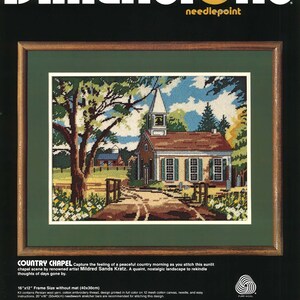 May include: A framed needlepoint kit titled "Country Chapel" depicting a rural scene with a church, trees, and a path. The kit includes wool yarn, cotton thread, and instructions. The frame size is 40x30cm.