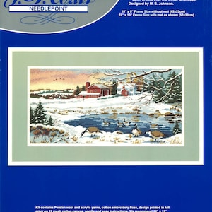 May include: Winter Sunrise needlepoint kit by J&P Coats. The kit includes Persian wool and acrylic yarns, cotton embroidery floss, a design printed on 12 mesh cotton canvas, a needle, and easy instructions. The design features a snowy winter scene with a farmhouse, a pond, and geese. The recommended frame size is 55 cm by 33 cm.