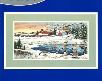 May include: Winter Sunrise needlepoint kit by J&P Coats. The kit includes Persian wool and acrylic yarns, cotton embroidery floss, a design printed on 12 mesh cotton canvas, a needle, and easy instructions. The design features a snowy winter scene with a farmhouse, a pond, and geese. The recommended frame size is 22 inches by 13 inches.