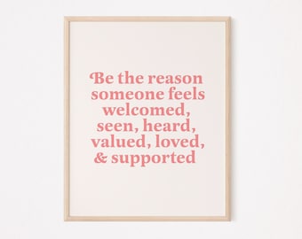 May include: A framed print with a pink inspirational quote that reads "Be the reason someone feels welcomed, seen, heard, valued, loved, & supported."