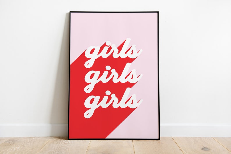 May include: A framed print with a pink and red background. The text "girls girls girls" is written in white on the red background.