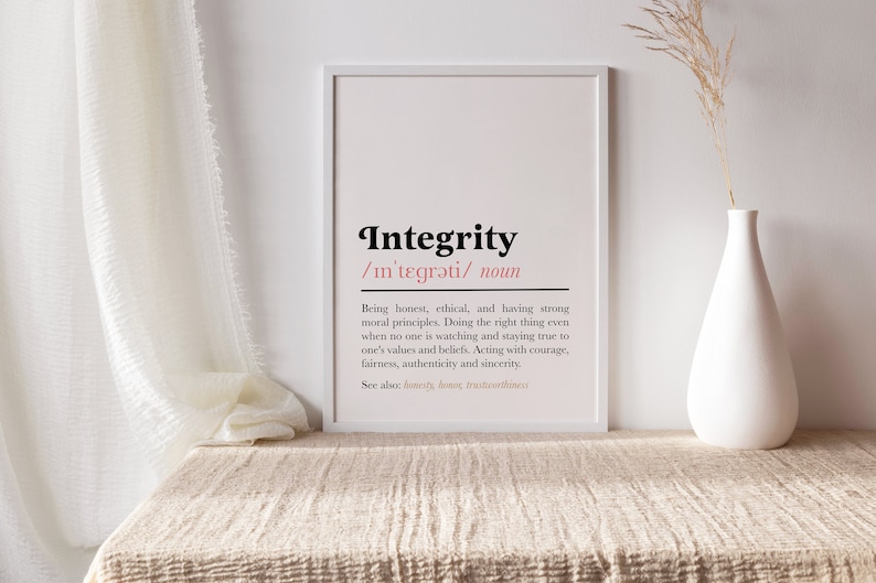 May include: A white framed print with the word "Integrity" in black text and a definition in smaller black text. The definition is: "Being honest, ethical, and having strong moral principles. Doing the right thing even when no one is watching and staying true to one's values and beliefs. Acting with courage, fairness, authenticity and sincerity. See also: honesty, honour, trustworthiness."