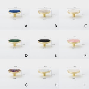 May include: Nine different round cabinet knobs with a brass base and a variety of stone tops. The knobs are 50mm in diameter and 10mm in height. The stone tops include blue, white, green, black, pink, multi-colored, and white with black flecks.