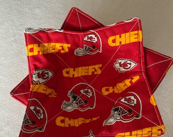 May include: Two red and yellow fabric pot holders with a pattern of Kansas City Chiefs logos and the word "Chiefs".