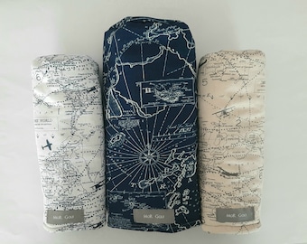 May include: Three golf club head covers with a world map design. The covers are in blue, white, and beige with the text "MOR Golf" on the bottom.