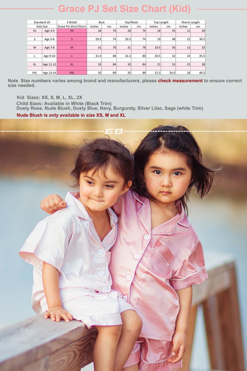 May include: Two girls wearing pink satin pajamas. The girl on the left is wearing a white pajama set and the girl on the right is wearing a pink pajama set. The size chart for the pajamas is shown in the background.