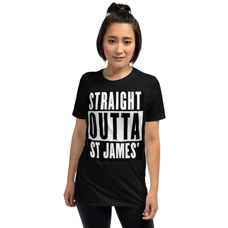 May include: Black t-shirt with the text "STRAIGHT OUTTA ST JAMES'" in a bold, white, rectangular design. The shirt is a short-sleeved, crew neck style.