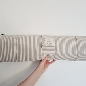 Cotton dog settle mat with shoulder strap and popper fastening. The mat for dogs helps with training a dog or puppy to settle. It makes a perfect gift for dogs and tool for puppy training. The puppy settle training pad is available is different colours and made easy to carry.