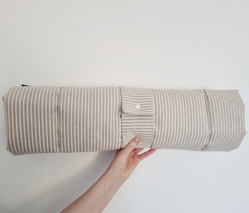 Cotton dog settle mat with shoulder strap and popper fastening. The mat for dogs helps with training a dog or puppy to settle. It makes a perfect gift for dogs and tool for puppy training. The puppy settle training pad is available is different colours and made easy to carry.