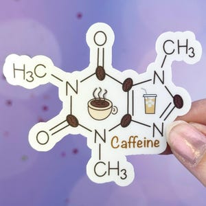 May include: White sticker with a chemical structure of caffeine, including the text "Caffeine". The structure is made up of a hexagon with nitrogen atoms, carbon atoms, and hydrogen atoms. There are two coffee cups and a glass of iced coffee in the center of the structure.