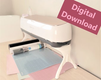 May include: A white Cricut Explore Air 2 cutting machine with a pink and white cutting mat, a blue cutting mat, and a black cutting mat. The machine is on a light wood surface. The text "Digital Download" is in pink on a red background.