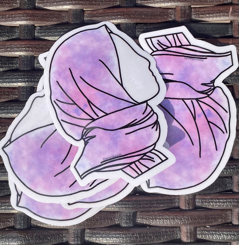 May include: Three purple and white watercolour stickers of a woman wearing a headscarf. The stickers are layered on top of each other.