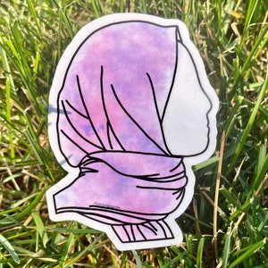 May include: A purple and pink watercolour sticker of a person wearing a headscarf. The sticker has a white outline and the text "@vickisboutique" is visible at the bottom.