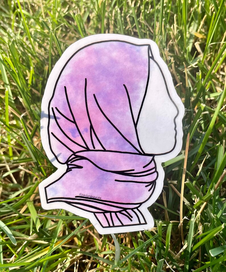 May include: A purple and pink watercolour sticker of a person wearing a headscarf. The sticker has a white outline and the text "@vickisboutique" is visible at the bottom.