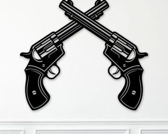 May include: Black metal wall art featuring two crossed revolvers. The revolvers are detailed with visible cylinders, triggers, and grips. The artwork is mounted on a white wall, creating a striking contrast. This piece is a decorative item.