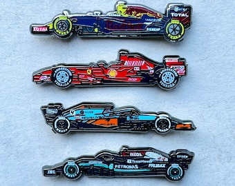 Formula 1 Enamel Pins: Mercedes, Red Bull, McLaren, Ferrari.