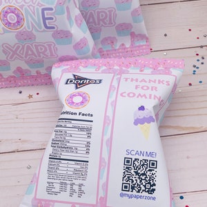 May include: A pink and white party favor bag with a donut and cupcake design. The bag is filled with Doritos chips and has a nutrition facts label on the side. The back of the bag has a QR code and the text "Thanks for coming" and "@mypaperzone".