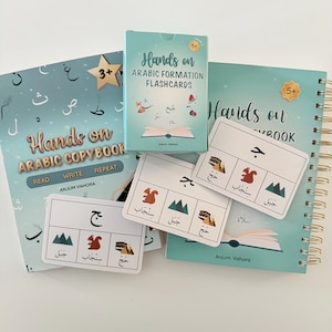 May include: A collection of educational materials for Arabic language learning. Includes a copybook, flashcards, and a spiral-bound notebook, all in shades of teal and white. The flashcards feature illustrations and Arabic script. The text "Hands on Arabic" is visible.